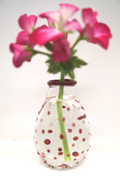 red glass bud vase on display