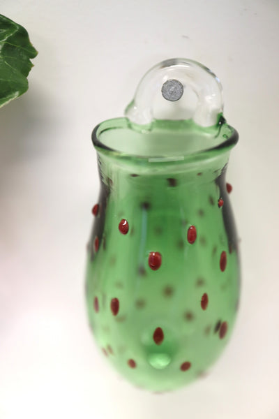 red dotted green wall vase on a hock
