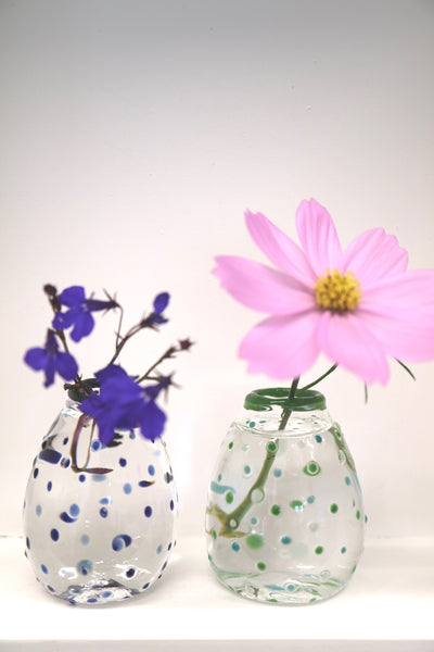 a single flower in glass bud vases 