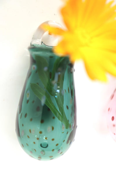dotted patterned turquoise wall hanging vase on display
