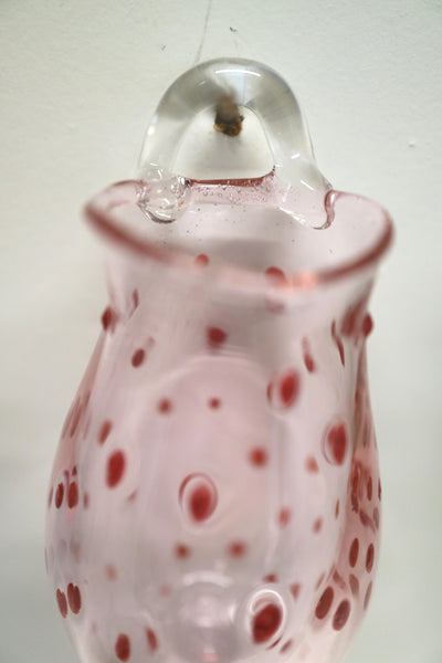red dotted pink vase on a hock