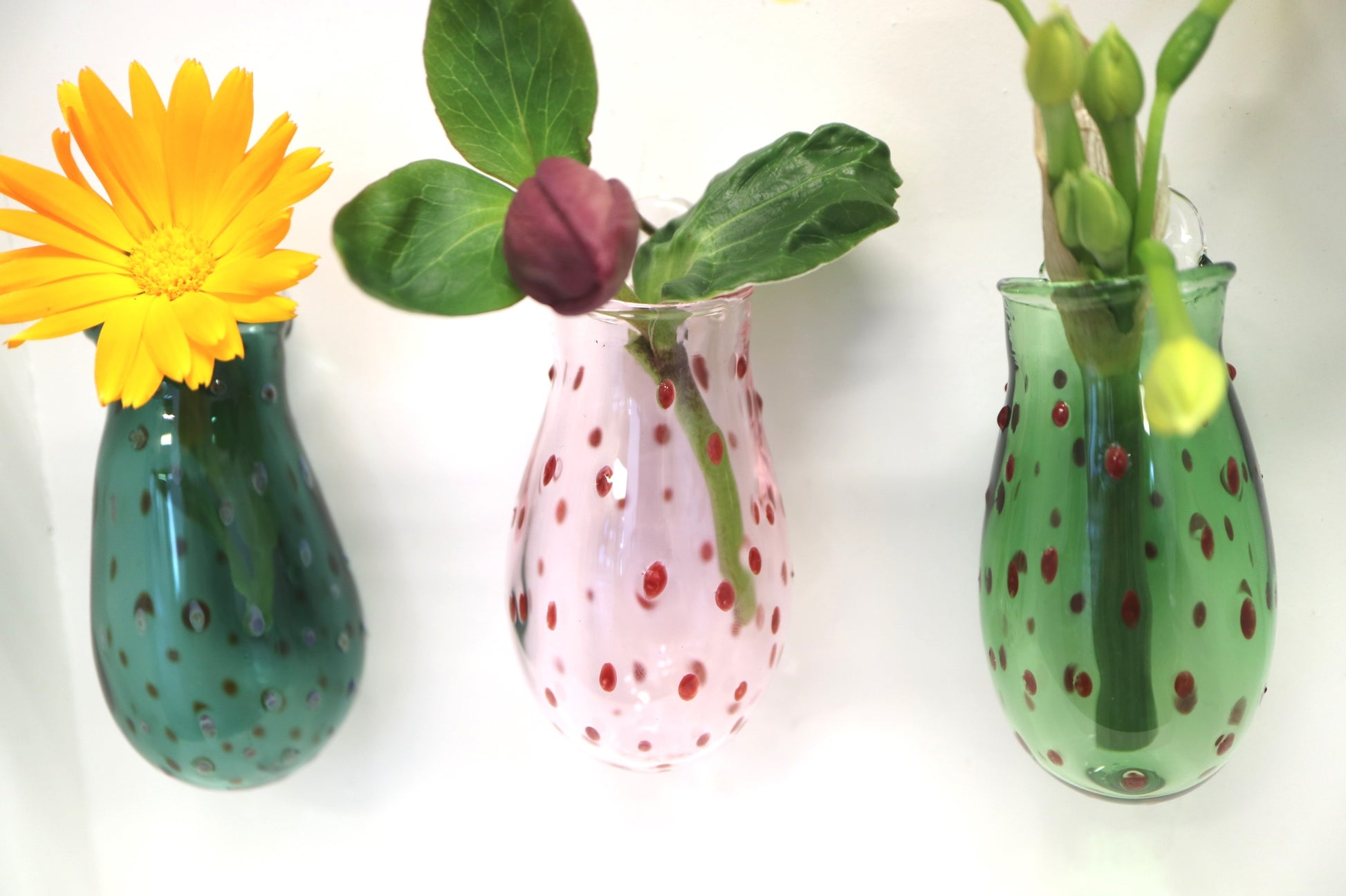 three wall vases in a line